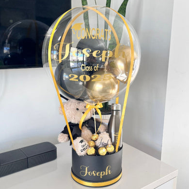 Graduation-themed balloon gift with personalised teddy bear and  chocolates..