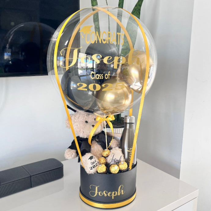 Graduation-themed balloon gift with personalised teddy bear and  chocolates..